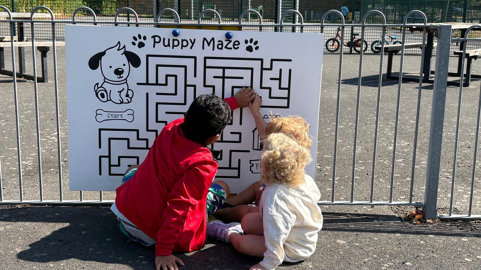 Children playing a puppy maze game